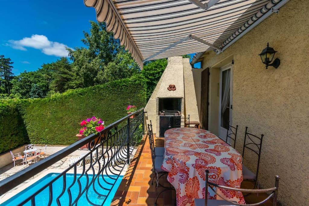 Balcony with awning, barbecue and dining table