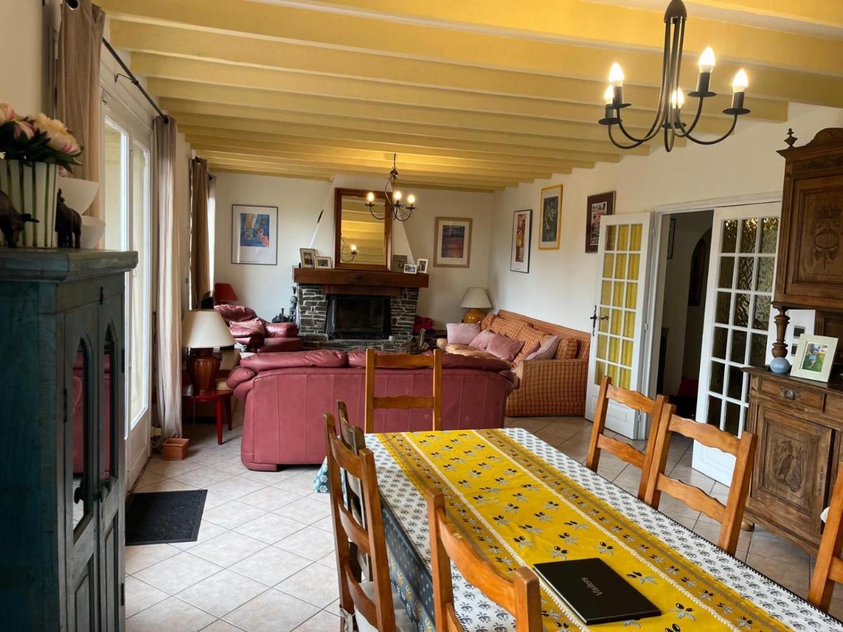 Living and dining room with beamed ceiling and fireplace